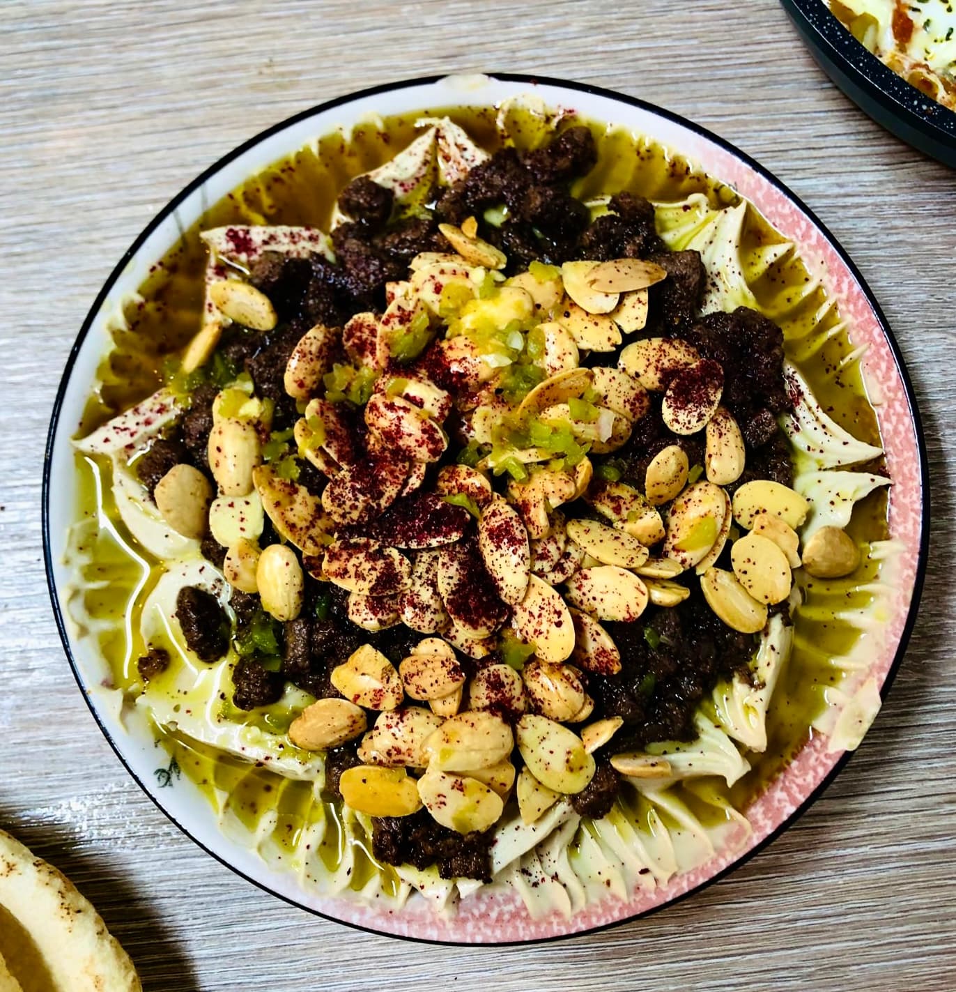 Kızarmış ekmek, nohut, kıyma ve bademle hazırlanmış fetteh tabağı
