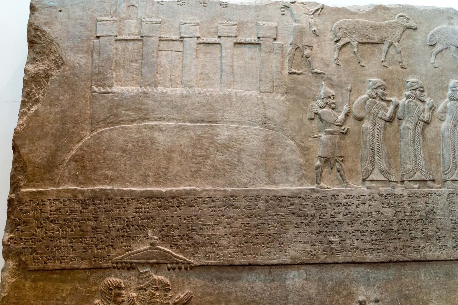 British Museum'daki Nimrud kabartması: surlu Aştarot kenti bir höyüğün üstünde, yanında sürgüne götürülen halk ve Asurlu asker, altta çivi yazısı şerit